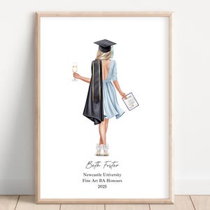 May include: Framed graduation print. The illustration shows a graduate in a gown and cap, holding a champagne flute and a diploma. Text reads "Beth Foster, Newcastle University, Fine Art BA Honours, 2025."