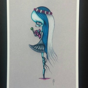 May include: A blue and white illustration of a girl with a skull and flower crown holding a heart. She is wearing a black dress and ballet shoes. The background is a light gray.
