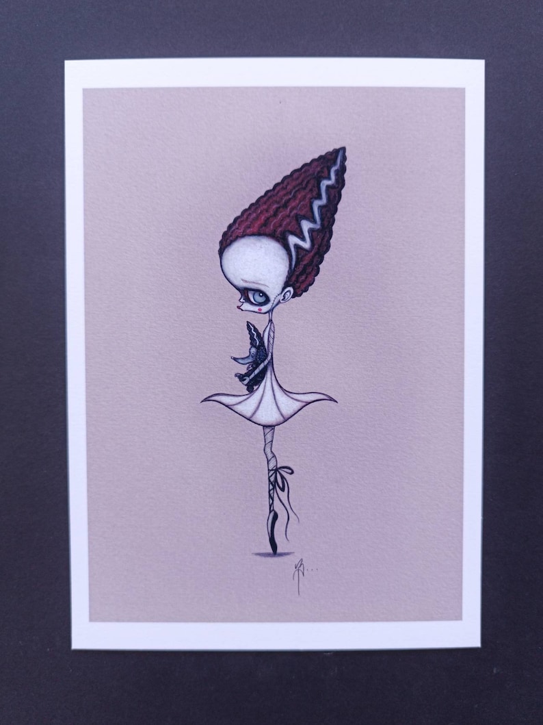 May include: A whimsical illustration of a ballerina with a green and black monster in her arms. She has a red and white hairdo with a lightning bolt pattern. The ballerina is wearing a white tutu and black shoes. The background is a light pink.