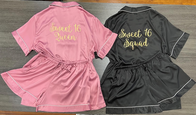 May include: Two matching pajama sets. One is pink with "Sweet 16 Queen" in gold script, the other is black with "Sweet 16 Squad" in gold script. Both sets include a short-sleeved top and shorts with white trim.