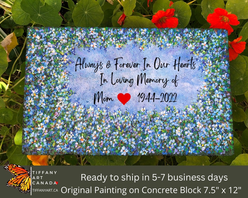 May include: A blue and white floral painting on a concrete block with the text "Always & Forever In Our Hearts In Loving Memory of Mom 1944-2022".