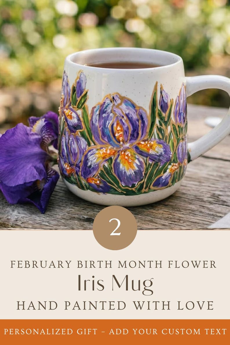 May include: A speckled white ceramic mug featuring hand-painted purple iris flowers with gold accents. The text on the image reads: 2, FEBRUARY BIRTH MONTH FLOWER, Iris Mug, HAND PAINTED WITH LOVE, PERSONALIZED GIFT - ADD YOUR CUSTOM TEXT.