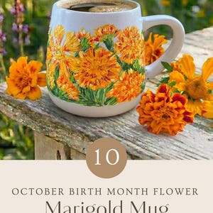 May include: A white ceramic mug featuring hand-painted orange marigold flowers. The text on the image reads: 10 OCTOBER BIRTH MONTH FLOWER Marigold Mug HAND PAINTED WITH LOVE PERSONALIZED GIFT - ADD YOUR CUSTOM TEXT.
