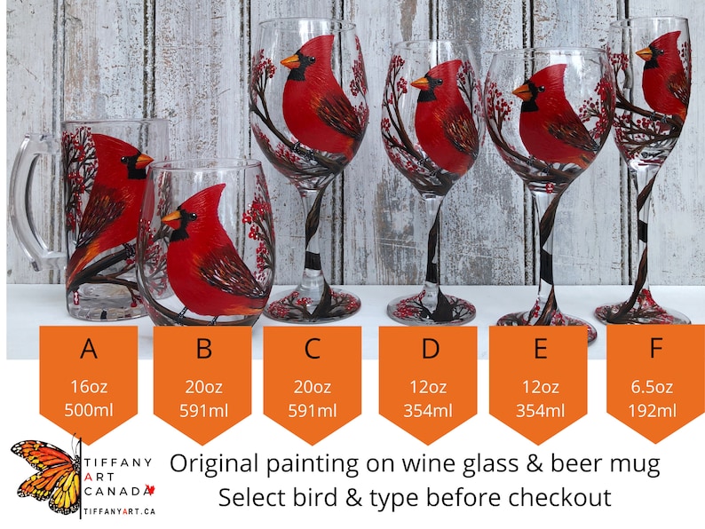 May include: A collection of hand-painted glassware featuring a vibrant red cardinal bird design. The set includes a beer mug, stemless wine glasses, and stemmed wine glasses. Each glass showcases the bird perched on a branch with red berries. The sizes range from 6.5oz to 20oz.