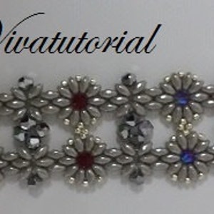 May include: A silver bracelet featuring a repeating pattern of silver flower-shaped beads with blue, red and turquoise accents. The bracelet is made with seed beads and has a silver clasp.