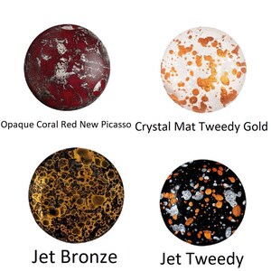 May include: Four round glass cabochons with different patterns and colors.  Opaque Coral Red New Picasso, Crystal Mat Tweedy Gold, Jet Bronze, Jet Tweedy.