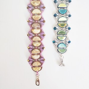 May include: Two beaded bracelets with different color schemes. The bracelet on the left has a purple, brown, and cream color scheme. The bracelet on the right has a silver, blue, and green color scheme.