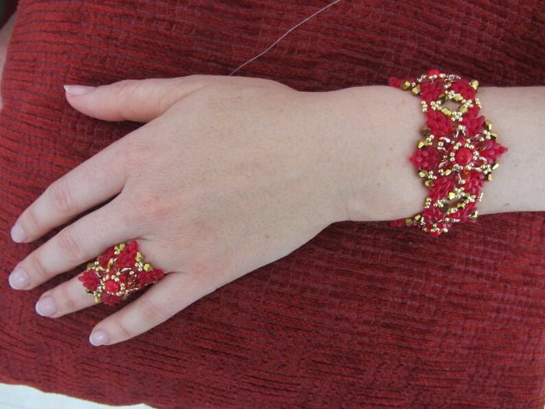 May include: A red and gold beaded bracelet and ring set. The bracelet is made with small red and gold beads, and the ring is a large, ornate design with red and gold beads.
