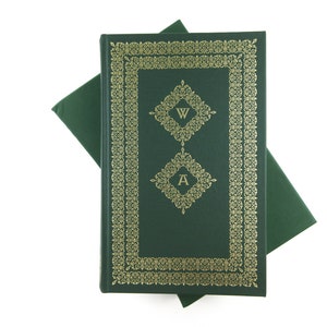 May include: A dark green hardcover book with a gold decorative border and the letters "W" and "A" in gold on the front cover.