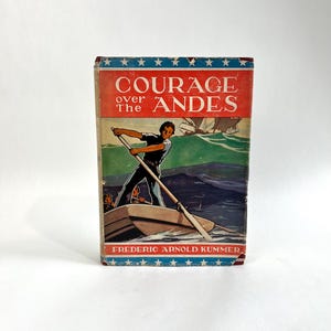 May include: Vintage book titled "Courage Over The Andes" by Frederic Arnold Kummer. The cover features a man rowing a boat on water, with mountains in the background. The top border is red with white stars.