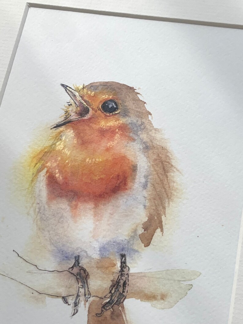 May include: A watercolour painting of a robin perched on a branch. The robin is facing the viewer with its beak open, as if singing. The bird is painted in shades of brown, orange, and white, with a hint of blue on its chest.