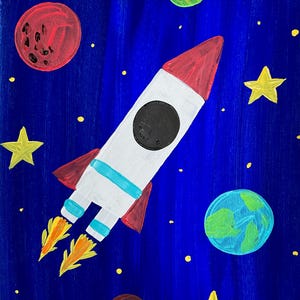May include: A colorful painting of a rocket ship soaring through a starry night sky. The rocket is white with red and blue accents, and flames are coming from the engines. Planets and yellow stars are scattered across the deep blue background.