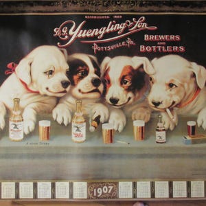 May include: Vintage A. Yuengling & Son Brewers and Bottlers advertisement featuring four puppies with bottles of beer and glasses. The image includes the text "Established 1829" and a 1907 calendar.