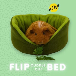 May include: A green and brown fleece "Flip Cuddle Cup" bed for small pets, with a guinea pig inside.