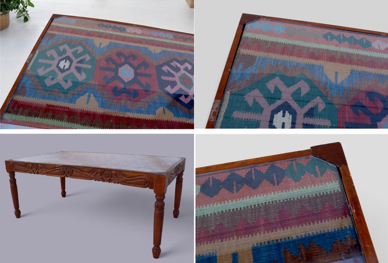 May include: A wooden coffee table with a glass top featuring a colorful patterned rug design. The table has a carved wooden base and four legs.