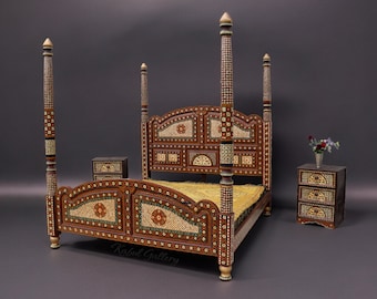 May include: A four-poster bed with intricate wood carvings and inlaid mother-of-pearl details. The bed frame is a rich brown colour with gold accents. The headboard features a decorative arched design. The bed is accompanied by two matching bedside tables.