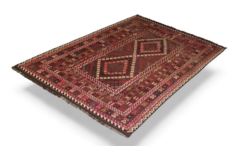 May include: A traditional red and brown rug with a geometric pattern. The rug has a fringe border and is made of wool.