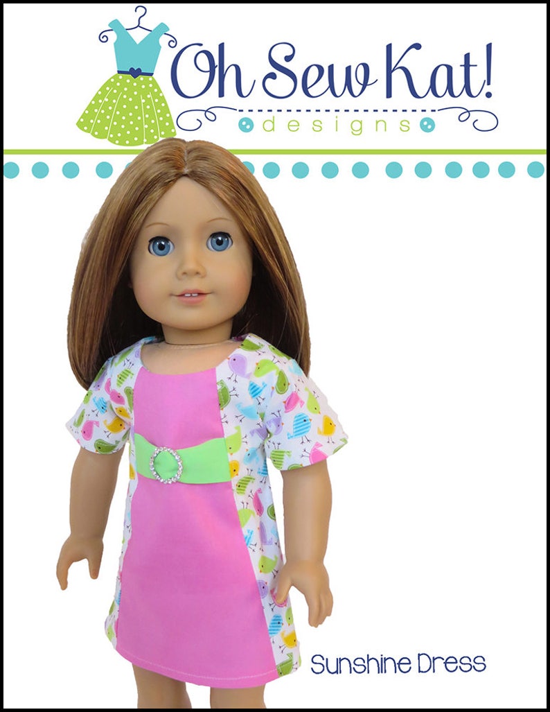 May include: A pink and white dress with a green belt and a bird print pattern. The dress is designed for a doll and is called "Sunshine Dress".