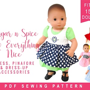 May include: PDF sewing pattern for a 15 inch doll dress, pinafore, and dress-up accessories. The pattern includes a blue and white polka dot dress, a green and white pinafore, and a red and white cape. The text "Sugar n Spice & Everything Nice" is featured on the pattern.