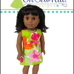 May include: A doll wearing a green and pink floral dress with a pink bow. The dress is called "Sunshine Dress" and is from "Oh Sew Kat! Designs".