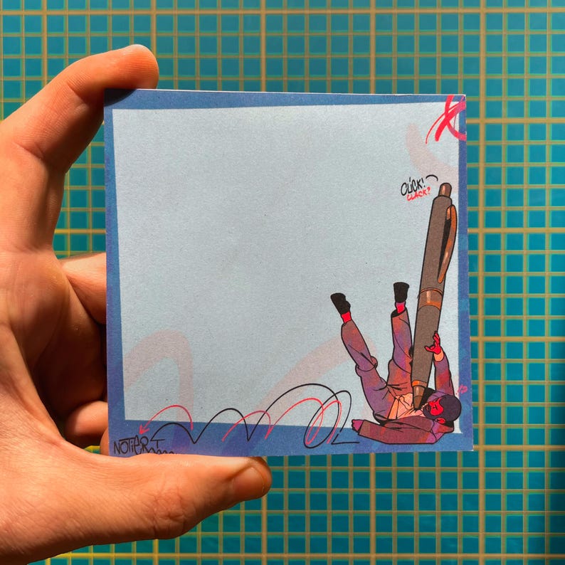 May include: A blue sticky note featuring a cartoon illustration of a person falling while holding a large pen. The illustration includes the text "click? clack?" and a signature. The note is held by a hand.
