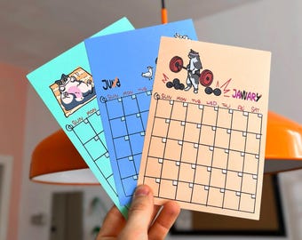 Cat Adventure - Yearly Table Calendar for your table or wall | with small clamp to hang on the wall