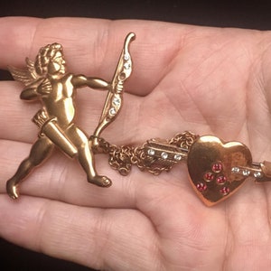 A charming vintage Angel and Heart statement brooch with divine quality and design