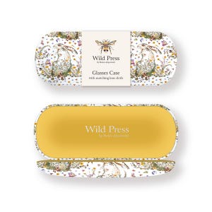 May include: An open glasses case with a yellow interior and a matching lid. The exterior features a white background with a floral and rabbit design. The case includes a matching lens cloth and the text "Wild Press".