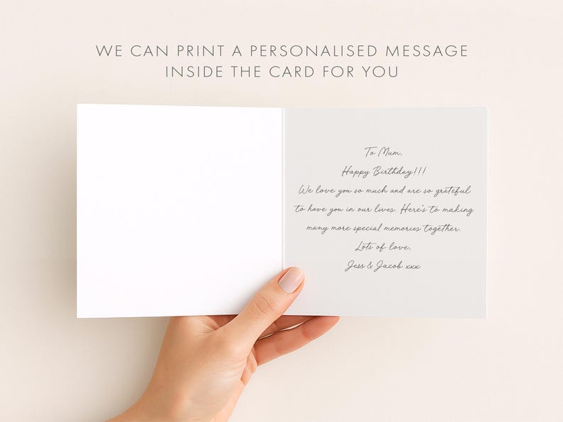 A hand holding an open birthday card with a personalized message inside.
