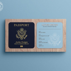 May include: A blue and white business card with the text "Axylus Designs" and the words "Design & Premium Printing". The card also includes a phone number, email address, website address, and social media handles.