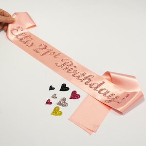 Personalised 21st Birthday Sash With Glitter Wording. Add your name or wording. Available in various combinations of ribbon & text colours