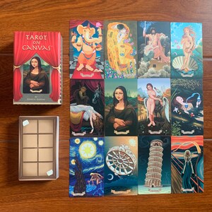 May include: Tarot card deck with a red and white box featuring the text "Tarot on Canvas" and a painting of the Mona Lisa. The cards feature famous paintings such as The Starry Night, The Scream, and The Creation of Adam.