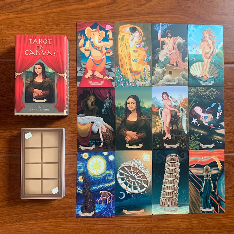 May include: Tarot card deck with a red and white box featuring the text "Tarot on Canvas" and a painting of the Mona Lisa. The cards feature famous paintings such as The Starry Night, The Scream, and The Creation of Adam.