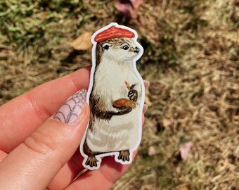 May include: A sticker of an otter wearing a red beret and holding a paint palette and paintbrush.