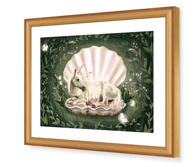 May include: A white unicorn with a pink horn lies in a large, pearl-coloured seashell. The shell is surrounded by green leaves and white flowers. There are several soap bubbles floating around the unicorn.
