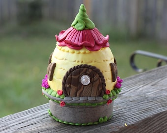 Yellow Tooth Fairy House night light with pink petal roof, pink and purple flowers