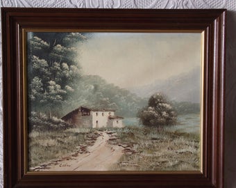 Framed oil/acrylic painting of isolated cottage in woodland setting