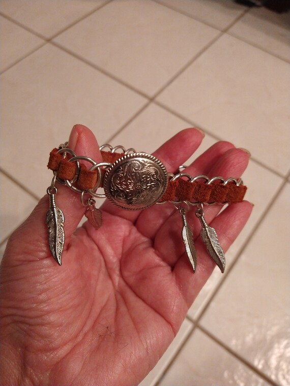 Unisex leather and Chrome with Sterling feathers a