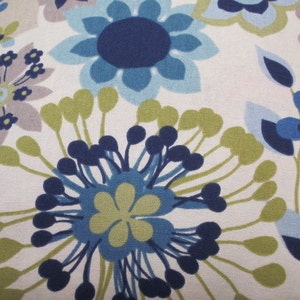 May include: Close-up of a floral pattern featuring large stylized flowers in shades of blue, green, and gray against a white background. The design has a retro, mid-century modern aesthetic, with a repeating pattern.