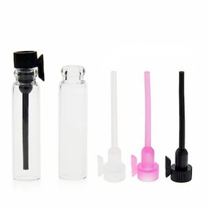 May include: Five clear glass bottles with black, white, and pink droppers. The bottles are all the same size and shape, and they are all empty.