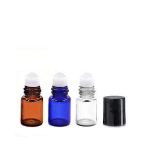 May include: Three glass roller bottles with white roller balls. The bottles are amber, blue, and clear. There is also a black plastic cap.