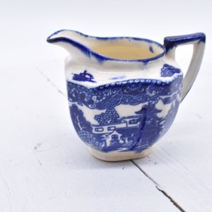 This is a ceramic Vintage Japan creamer  blue and white. #012323