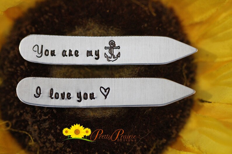 May include: Two silver tie clips with engraved messages. The top clip reads "You are my" with a small anchor symbol. The bottom clip reads "I love you" with a heart symbol.