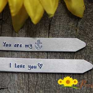 May include: Two silver metal tags with engraved messages. The top tag reads "You are my" with an anchor symbol. The bottom tag reads "I love you" with a heart symbol.