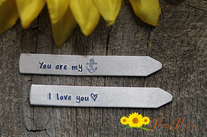 May include: Two silver metal tags with engraved messages. The top tag reads "You are my" with an anchor symbol. The bottom tag reads "I love you" with a heart symbol.