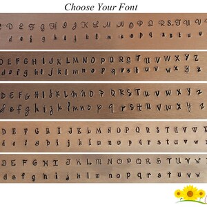 May include: Five different font styles are shown in uppercase and lowercase letters. The fonts are displayed on a brown background. The text "Choose Your Font" is at the top of the image.