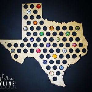 May include: A wooden cutout of the state of Texas with circular holes for bottle caps. The holes are filled with various colored bottle caps. The cutout is on a black background.