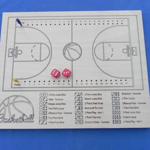 May include: A wooden basketball game board with a court design, dice, and game pieces. The board features a basketball court layout with scoring and game play options. The word "Basketball" is written on the board.