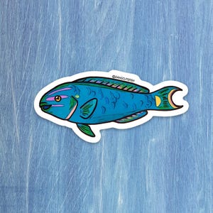 May include: A sticker featuring a cartoon fish with a blue body, green fins, and a yellow tail. The fish has pink and yellow accents and the text "@DANGCUTEFISH". The sticker is on a blue background.