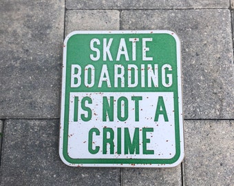 Skateboarding is not a crimeSign - Photo on Wood